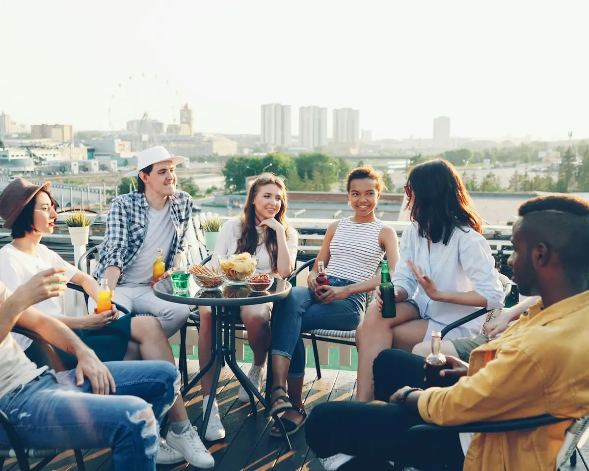 A group sharing a meal on a rooftop